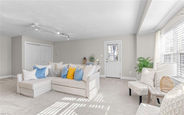 living room with light colored carpet and ceiling fan