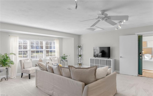 carpeted living room featuring ceiling fan