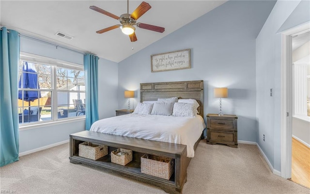 bedroom featuring ceiling fan, light colored carpet, and vaulted ceiling