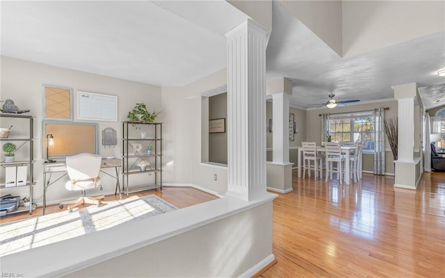 interior space with light hardwood / wood-style floors and decorative columns