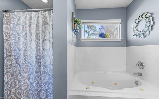 bathroom with a relaxing tiled tub