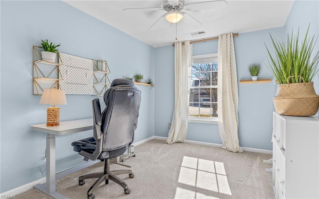 carpeted home office with ceiling fan