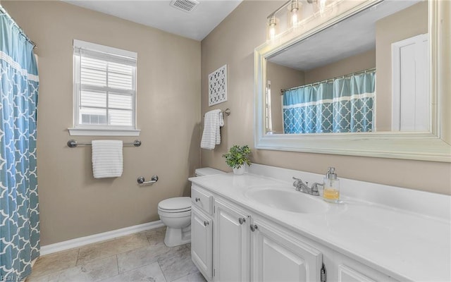 bathroom featuring tile patterned floors, vanity, and toilet