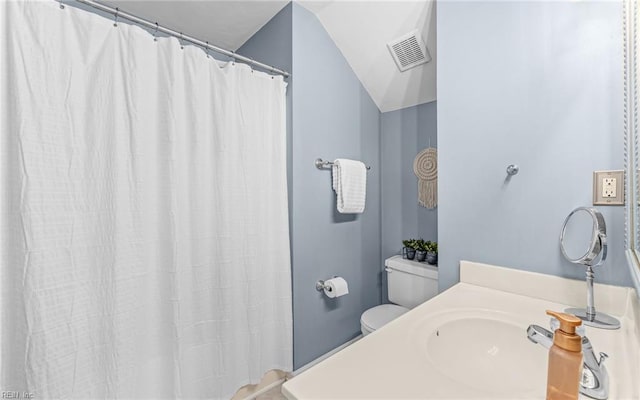 bathroom featuring sink, vaulted ceiling, and toilet