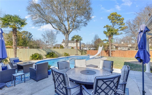 view of patio featuring a fire pit and a fenced in pool