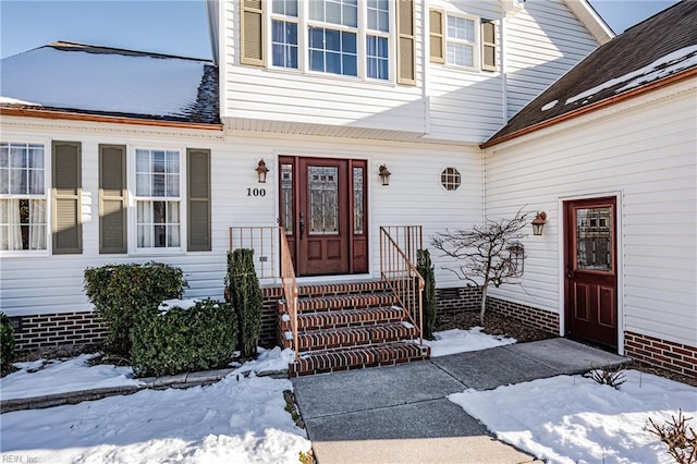 view of snow covered property entrance