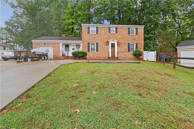 colonial house with a garage and a front lawn