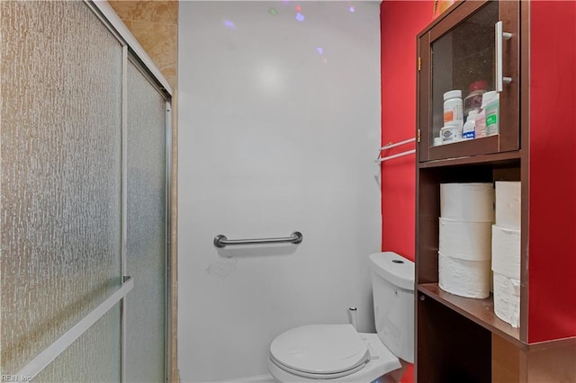 bathroom featuring toilet and walk in shower