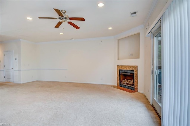 unfurnished living room featuring ornamental molding, ceiling fan, and light colored carpet