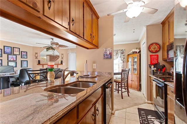 kitchen featuring black appliances, light tile patterned floors, ornamental molding, light stone counters, and sink