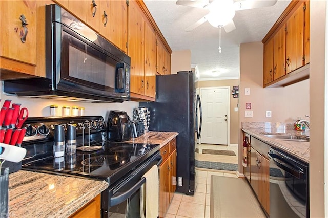 kitchen featuring black appliances, crown molding, light tile patterned floors, a textured ceiling, and sink