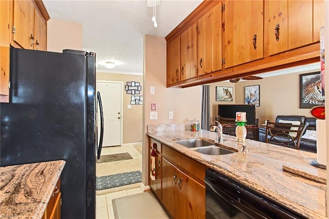 kitchen featuring ornamental molding, light tile patterned flooring, black appliances, and sink