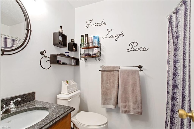 bathroom featuring toilet and vanity