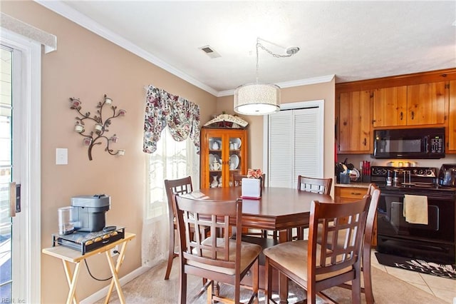 dining room featuring ornamental molding and light tile patterned floors