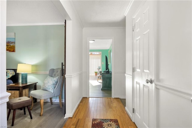 hallway featuring crown molding and wood-type flooring