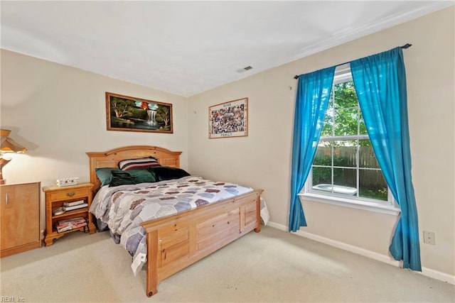 bedroom featuring light colored carpet