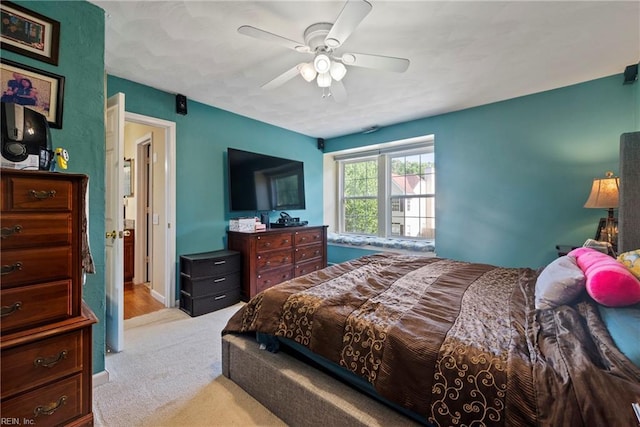 bedroom with ceiling fan and light colored carpet