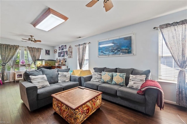 living room with ceiling fan and dark hardwood / wood-style flooring