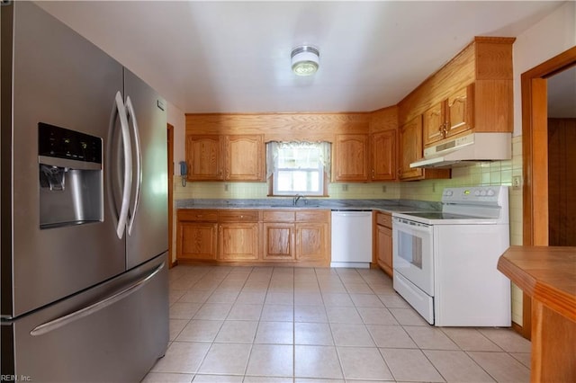 kitchen featuring sink, white appliances, tasteful backsplash, and light tile patterned floors