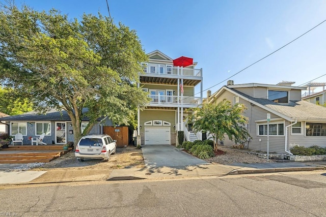 view of front of property featuring a balcony and a garage