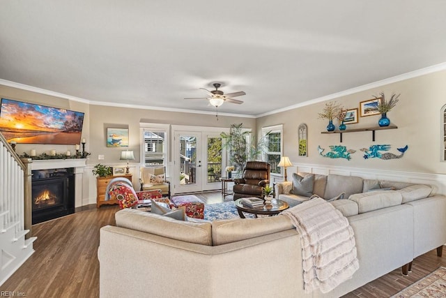 living room featuring ceiling fan, dark wood-type flooring, french doors, and crown molding