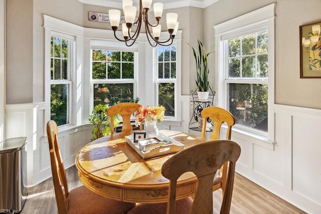 dining room featuring light wood-type flooring, a chandelier, and plenty of natural light