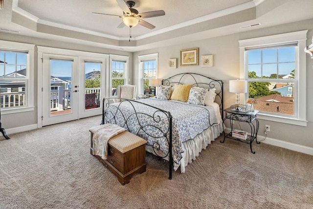 carpeted bedroom featuring ceiling fan, french doors, a raised ceiling, and access to exterior