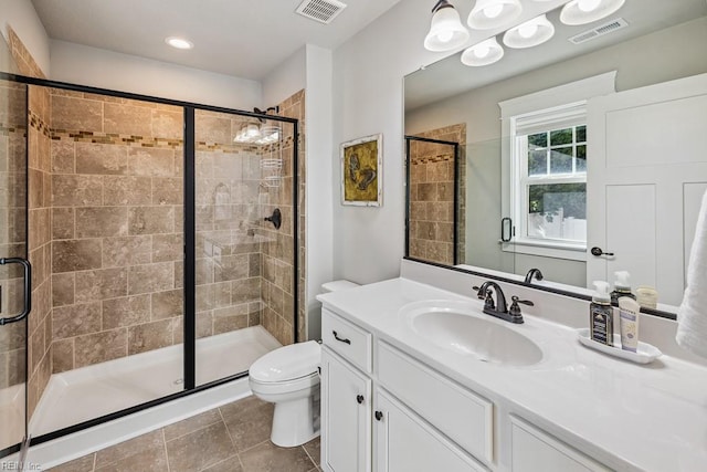 bathroom with toilet, an enclosed shower, vanity, and tile patterned floors