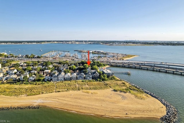 birds eye view of property featuring a beach view and a water view