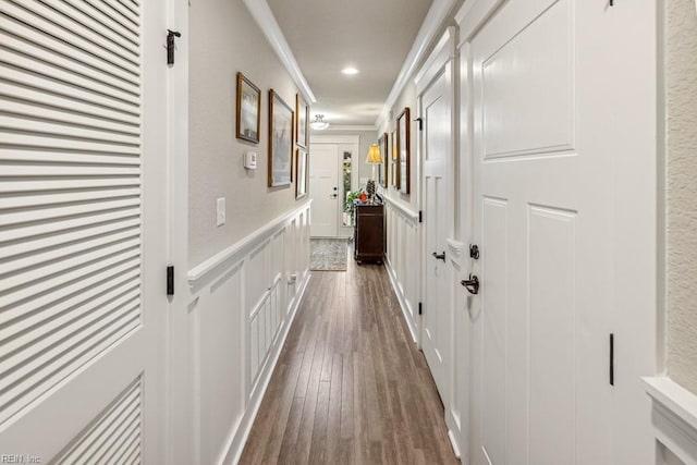 corridor featuring ornamental molding and dark hardwood / wood-style floors