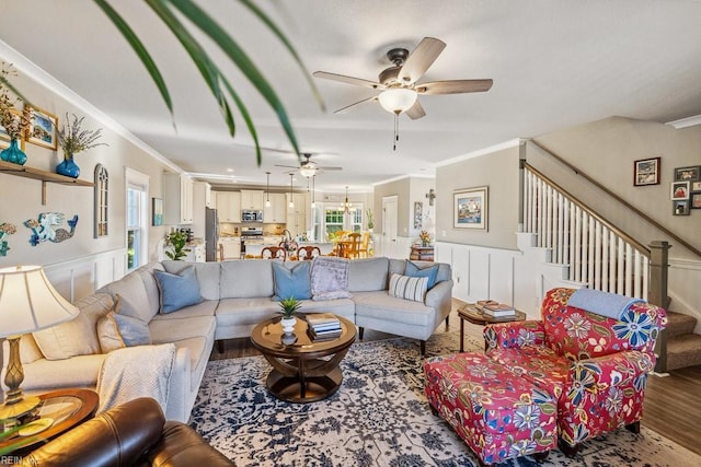 living room featuring ornamental molding, ceiling fan, and hardwood / wood-style floors