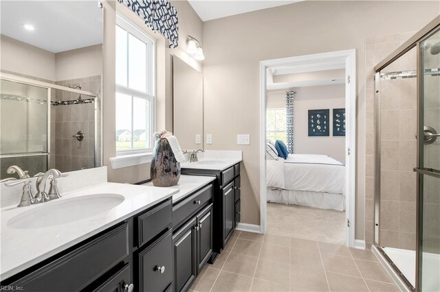 bathroom featuring tile patterned floors, an enclosed shower, and plenty of natural light