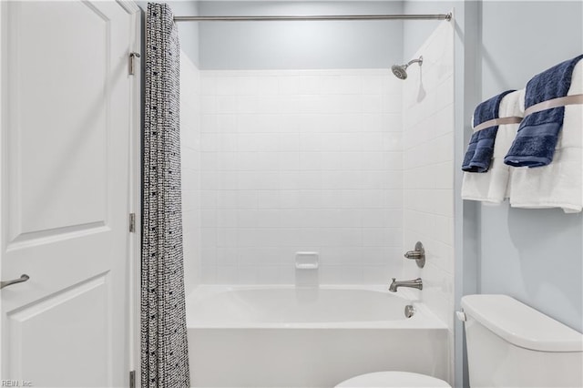 bathroom featuring toilet and shower / tub combo with curtain