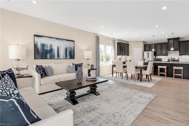 living room featuring light hardwood / wood-style floors and sink