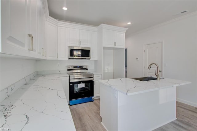 kitchen featuring sink, crown molding, white cabinetry, a kitchen island with sink, and appliances with stainless steel finishes