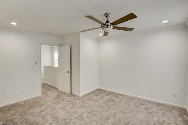 carpeted empty room featuring ceiling fan and ornamental molding