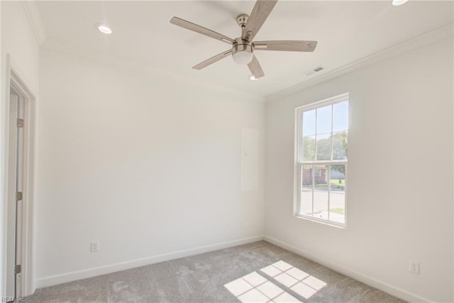 carpeted empty room with ceiling fan and crown molding