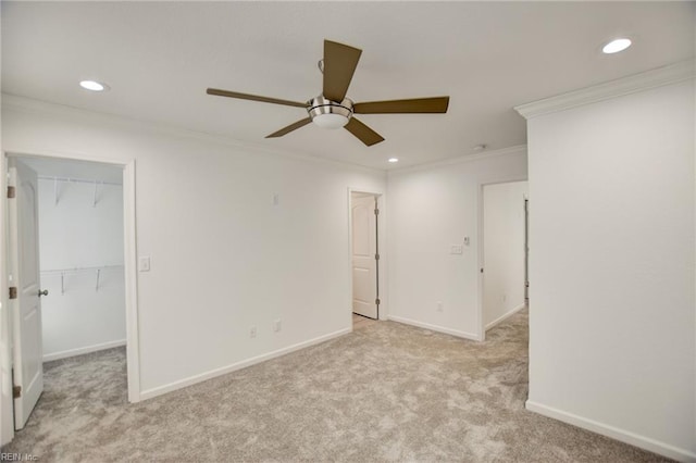 unfurnished room featuring light carpet, ceiling fan, and ornamental molding