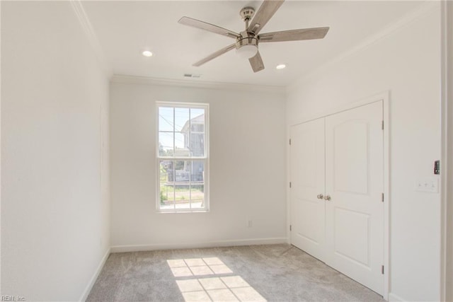 unfurnished bedroom with ceiling fan, light carpet, and multiple windows