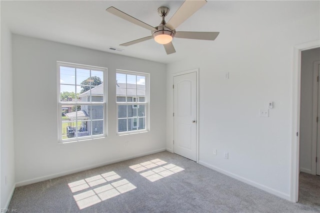 unfurnished room with ceiling fan and light colored carpet