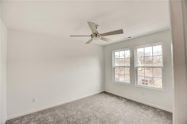 unfurnished room featuring ceiling fan and carpet