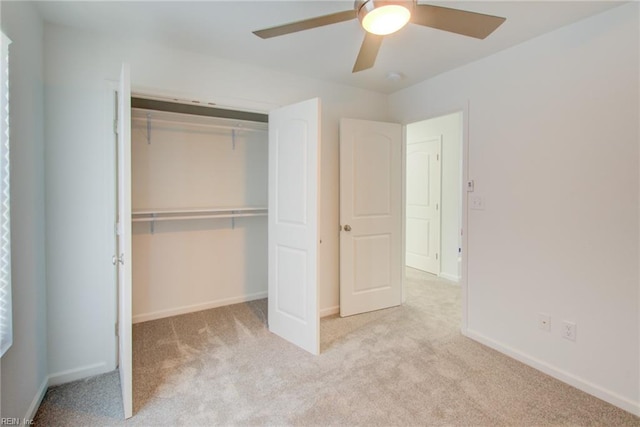 unfurnished bedroom featuring ceiling fan, light carpet, and a closet