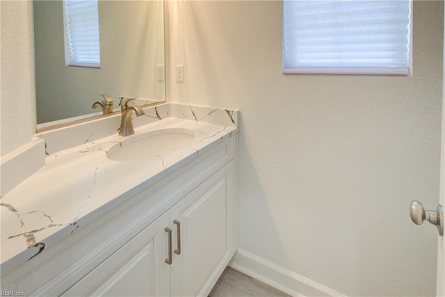 bathroom featuring a wealth of natural light and vanity