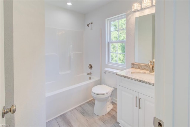 full bathroom featuring a wealth of natural light, toilet, vanity, and shower / washtub combination