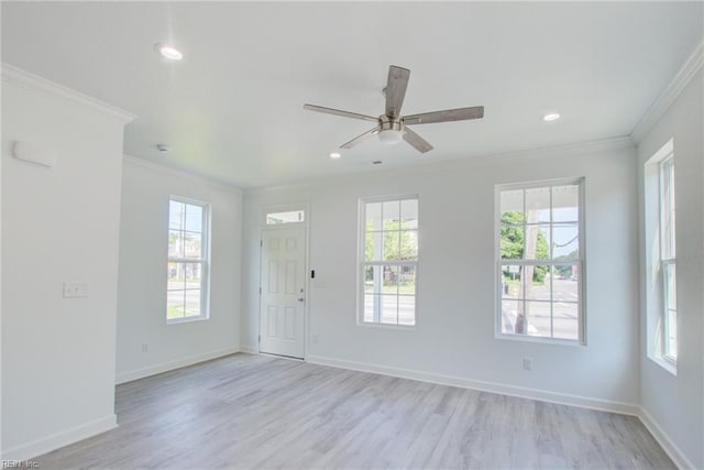 empty room with ceiling fan, light hardwood / wood-style floors, and ornamental molding