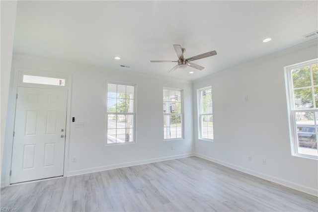 unfurnished room with light hardwood / wood-style floors, crown molding, and ceiling fan