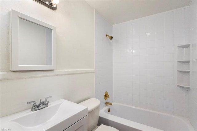 full bathroom with tiled shower / bath combo, toilet, vanity, tile walls, and decorative backsplash