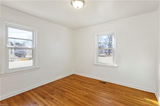 empty room with hardwood / wood-style flooring