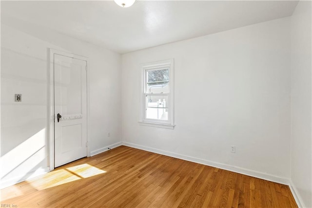 empty room with hardwood / wood-style flooring