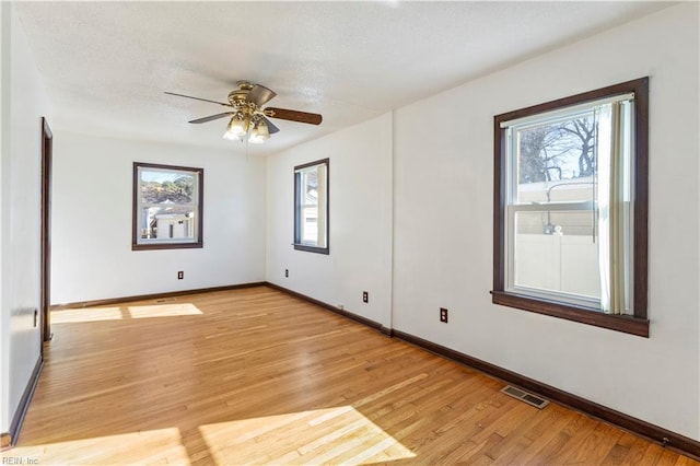 empty room featuring ceiling fan and light hardwood / wood-style flooring